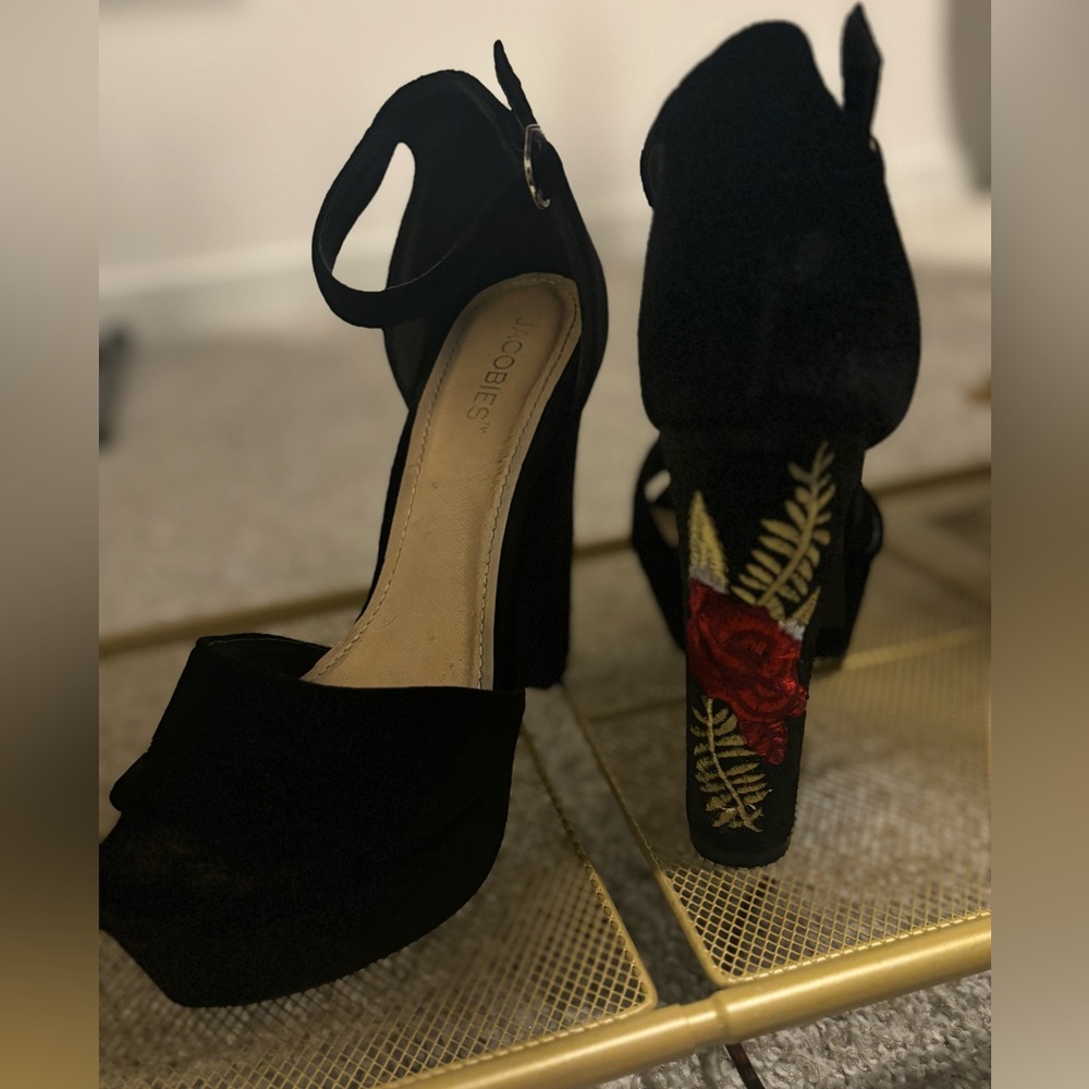 Platform heels with flower on the back . All black base . Worn only twice.